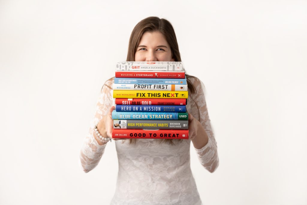 Clare with CL Content Marketing holding books she has read