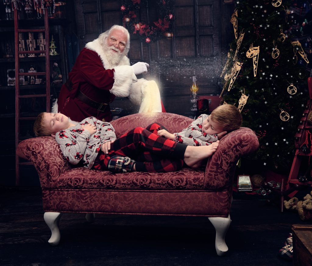 two boys sleeping when Santa sneaks in