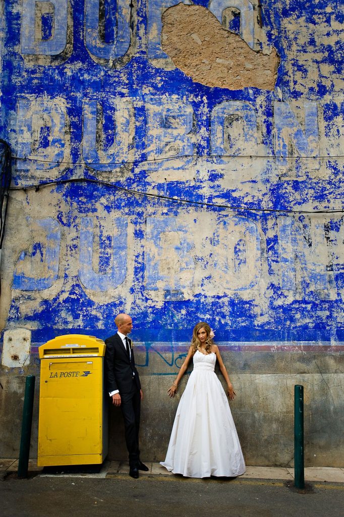 wedding image or couple standing by a blue wall by Longielier Photography