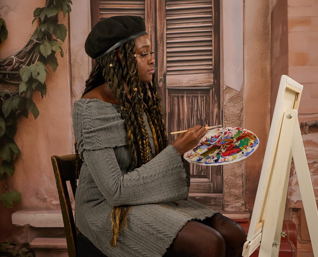 Young lady painting portrait