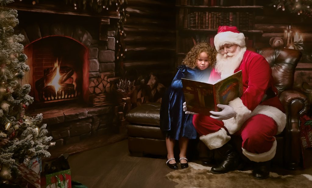 Santa reading to little girl in