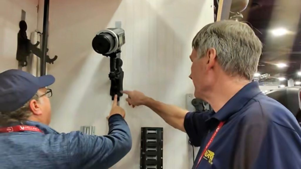 Gary demonstrating how the TogDrop backdrop system is safely secured to the wall during a live trade show demo
