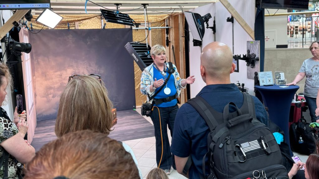 Photographer discussing her business goals and conference objectives with other attendees at a photography event