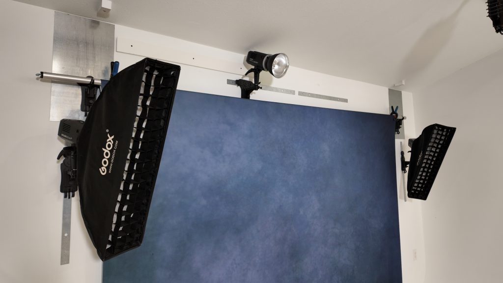 Photographer in their studio using a streamlined backdrop setup after implementing new systems learned at a photography conference