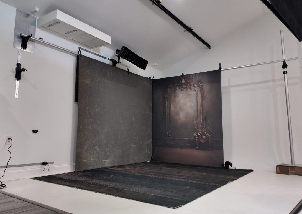 corner backdrop setup using metal wall and stand in small photography studi