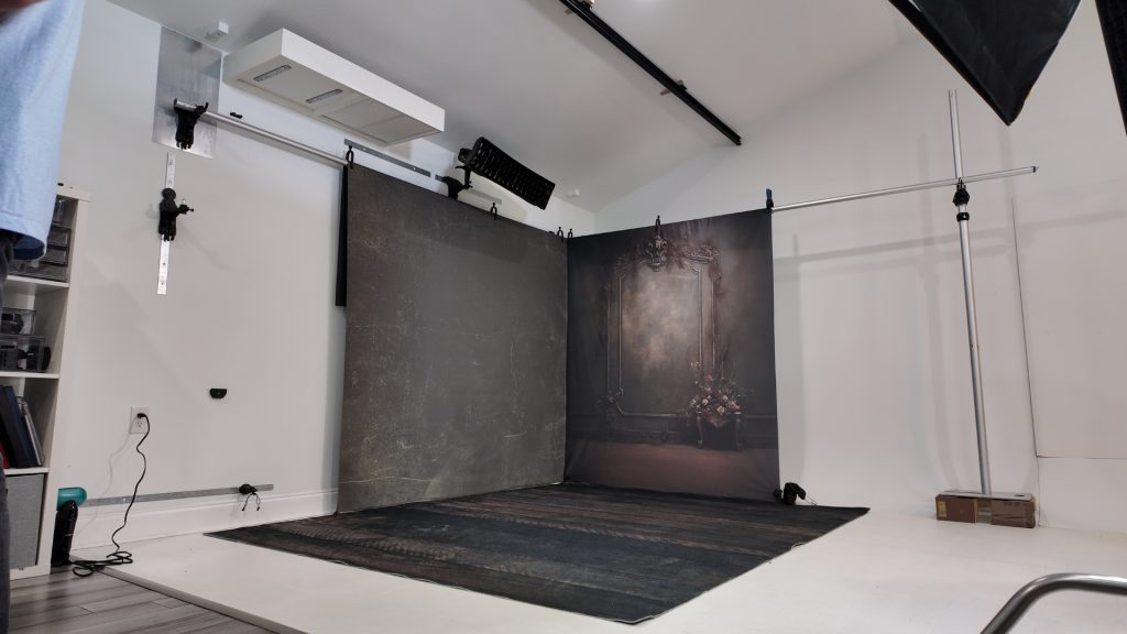 corner backdrop setup using metal wall and stand in small photography studi