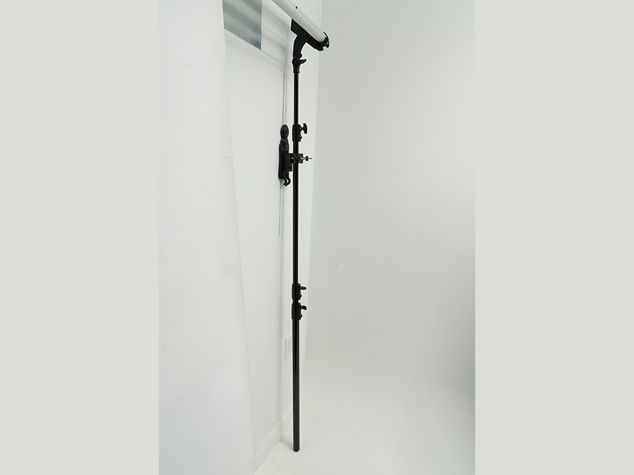 StandFree no-ladder backdrop system mounted on wall with adjustable bars for easy backdrop positioning