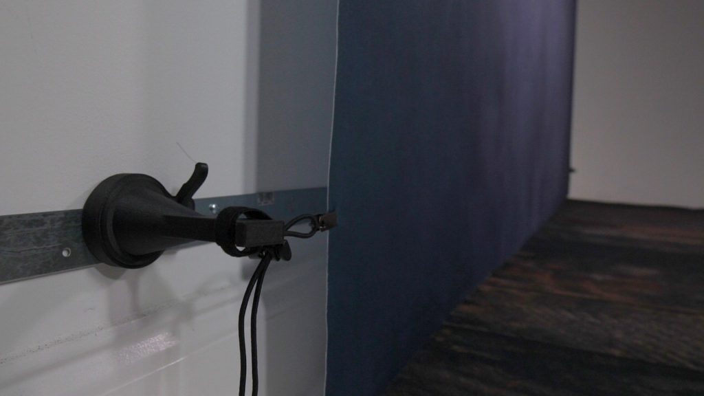 clean photography studio floor with wall mounted gear system