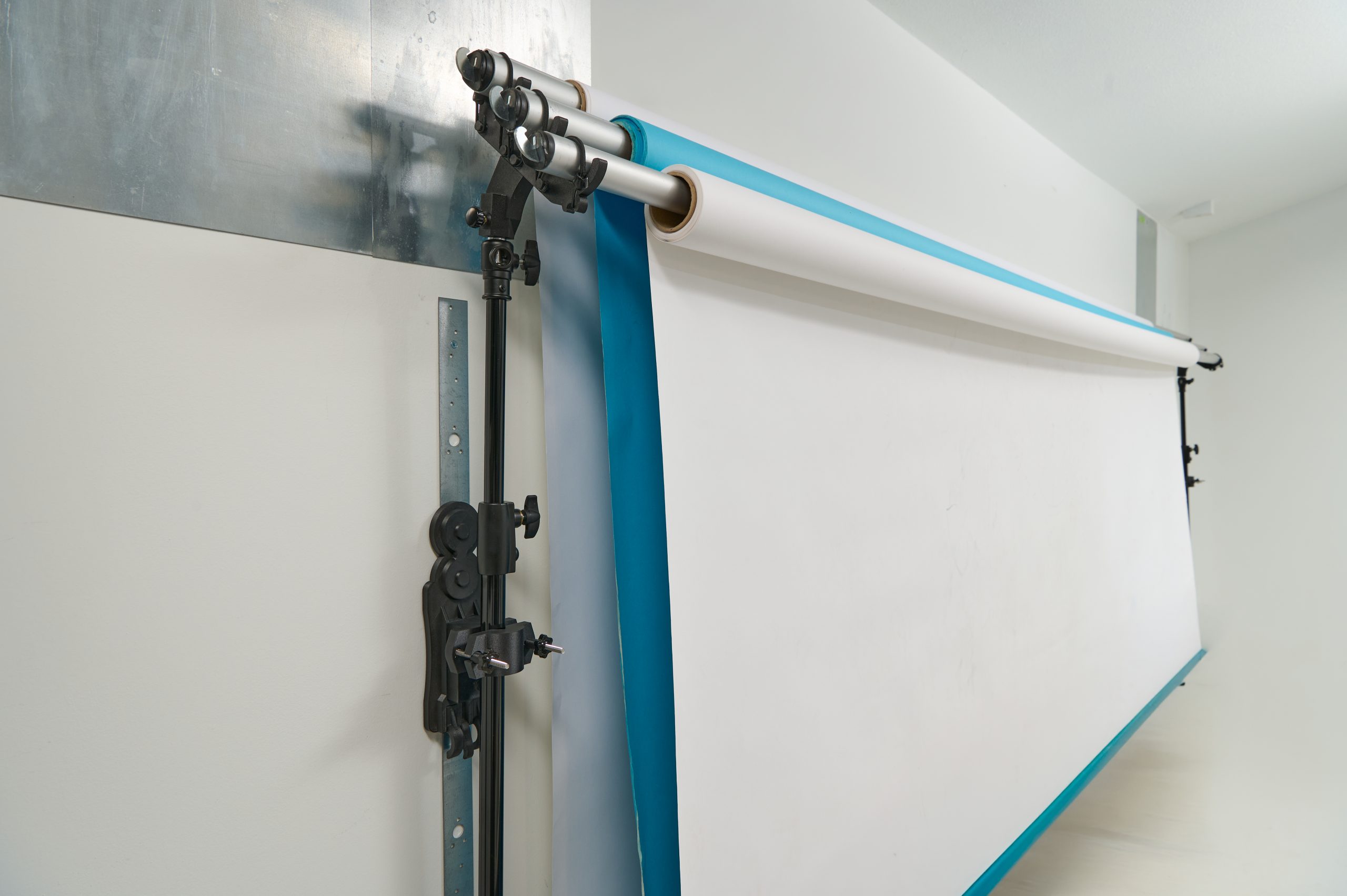 StandFree triple backdrop holder supporting three 10 foot paper rolls on crossbars