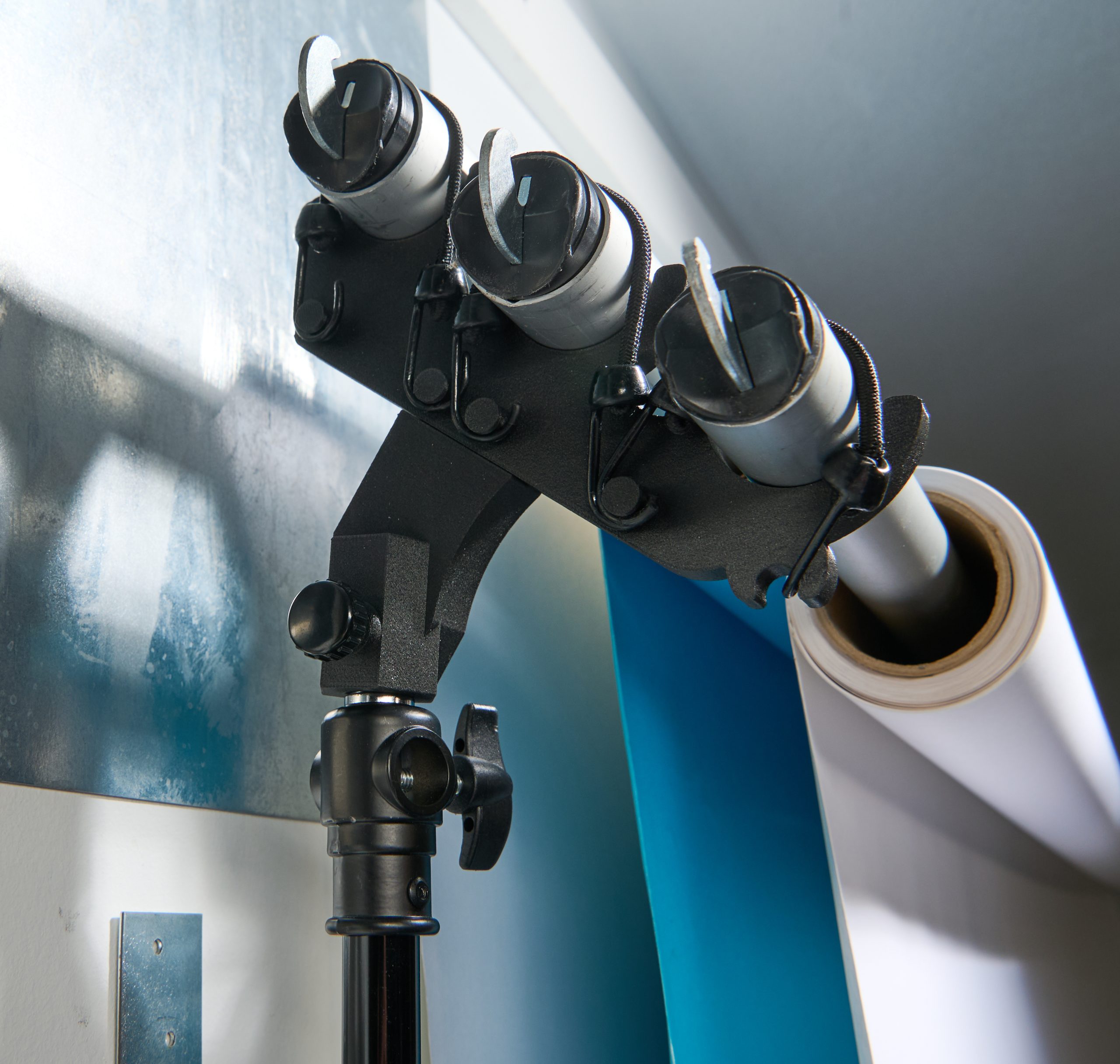 StandFree triple backdrop holder system showing three crossbar positions for holding multiple backdrops