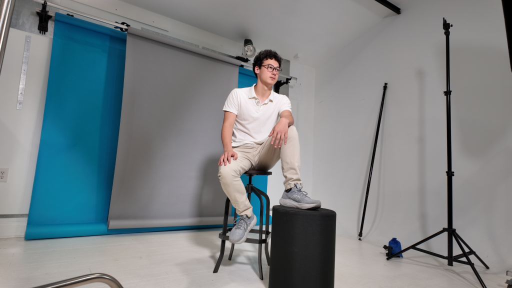 photographer taking a photo in clean organized studio space