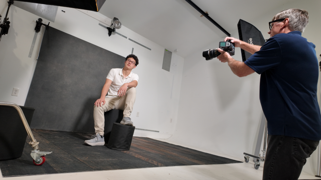 client posing comfortably in clean organized photography studio