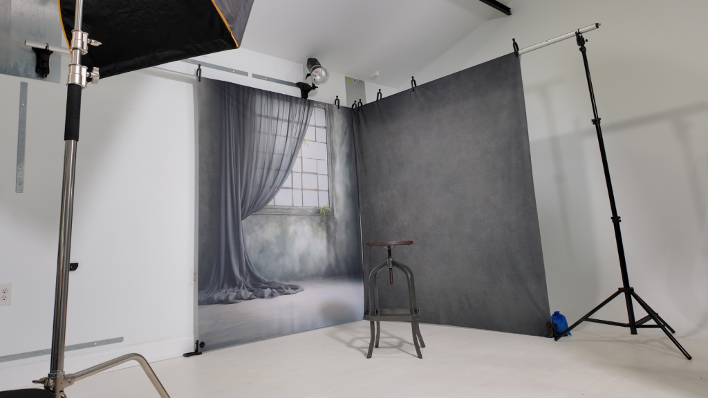 Corner backdrop system creating a soft ethereal senior portrait look in a small studio