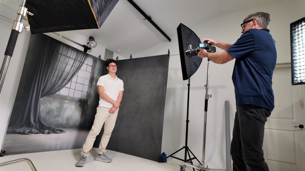 photographer using a clean modular photography studio setup with client