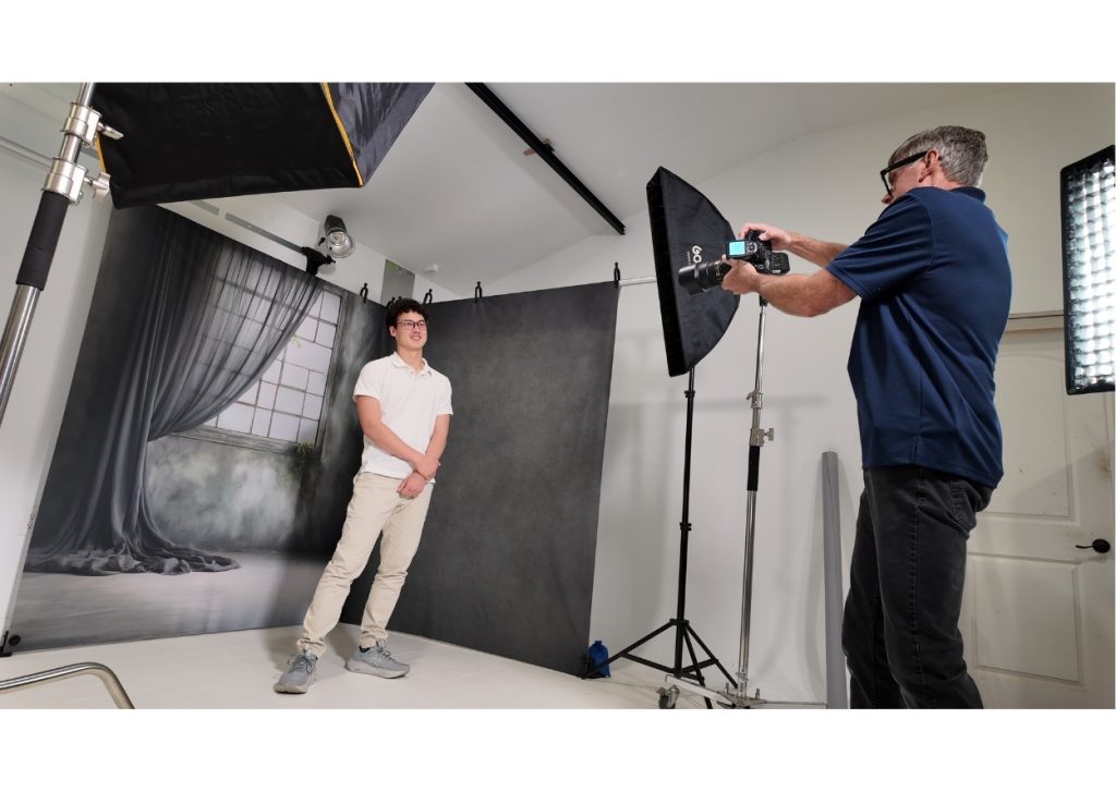photographer using a clean modular photography studio setup with client.1