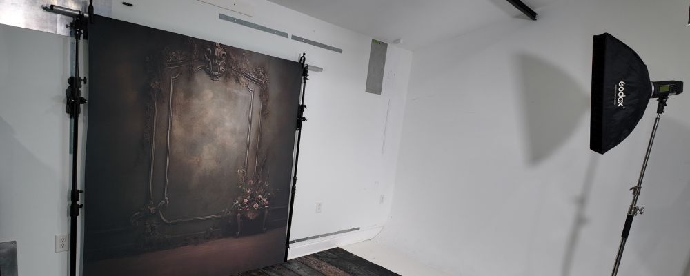 TogDrop StandFree no-ladder backdrop system installed in a small photography studio with clean open floor space.