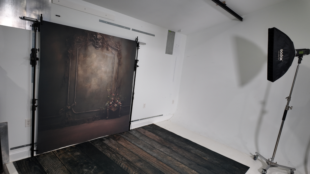 TogDrop StandFree no-ladder backdrop system installed in a small photography studio with clean open floor space.