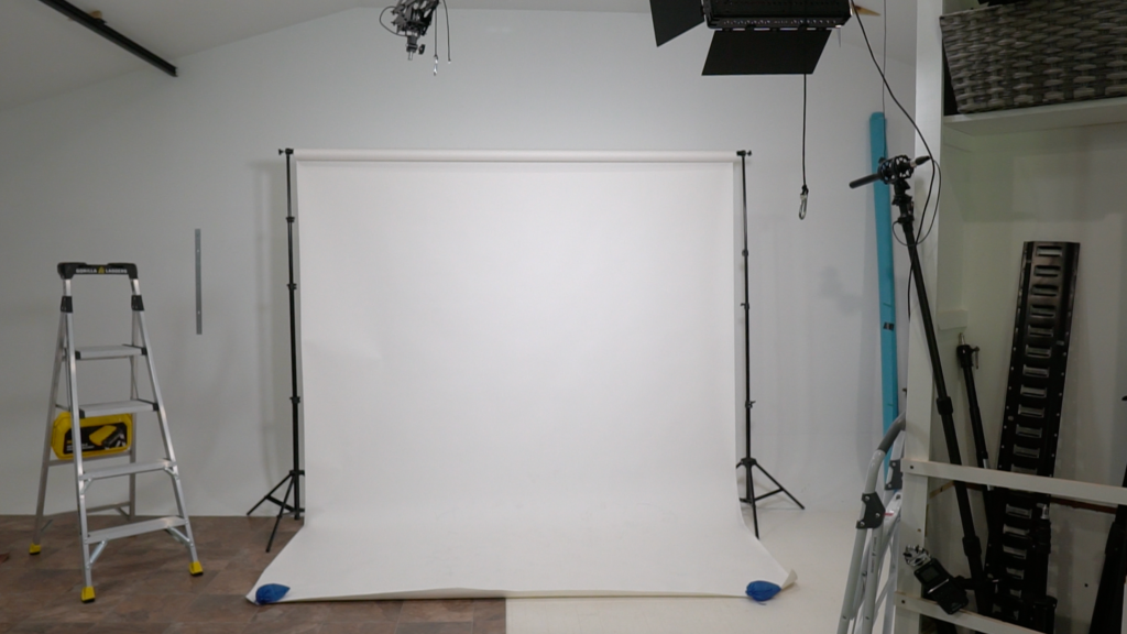 Traditional backdrop stand setup creating clutter and reducing workflow efficiency in a small photography studio