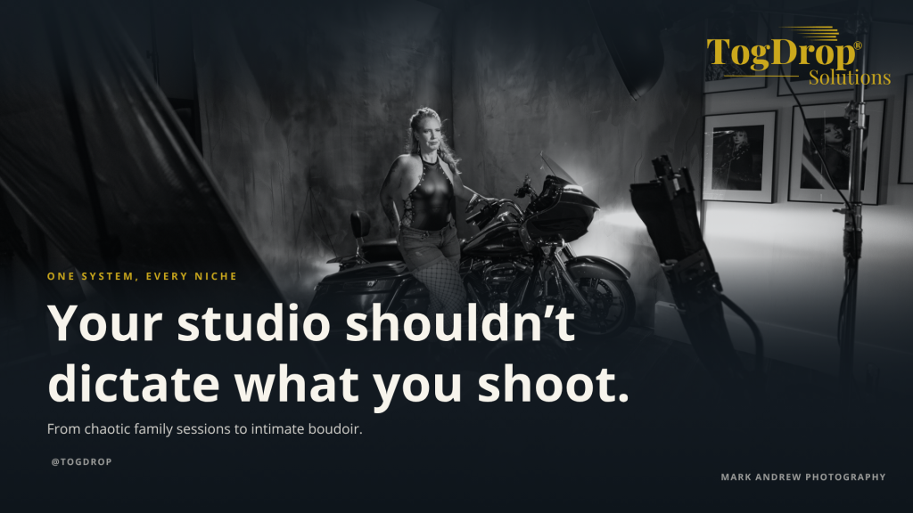 Boudoir photographer working in a clean studio with a wall-mounted backdrop system designed for multiple photography niches.
