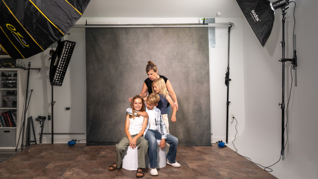 Family portrait session using a wall mounted backdrop and lighting system in a photography studio